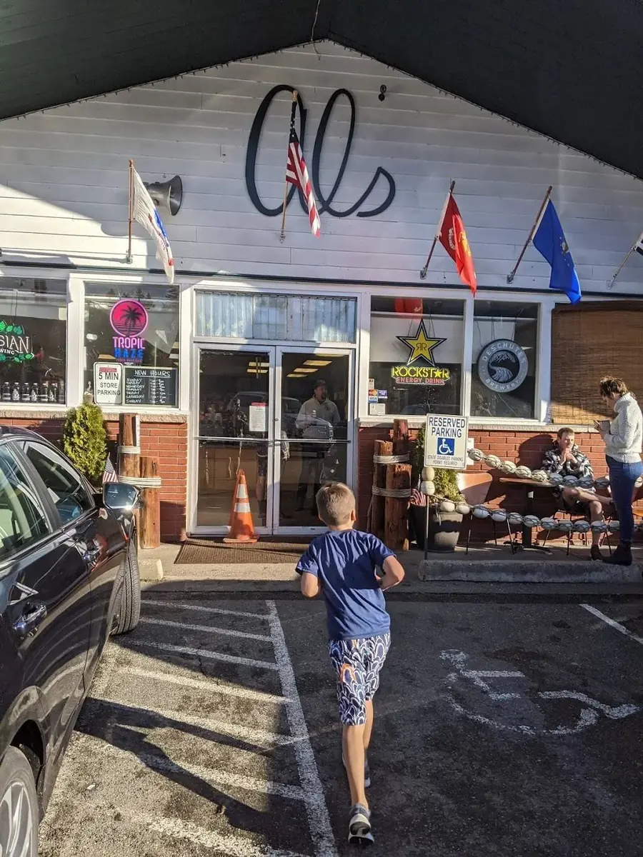 The front of Al's with its big script sign, flags along the gable and neon beer signs in the windows